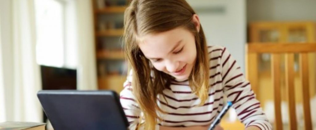 Young girl writing on paper