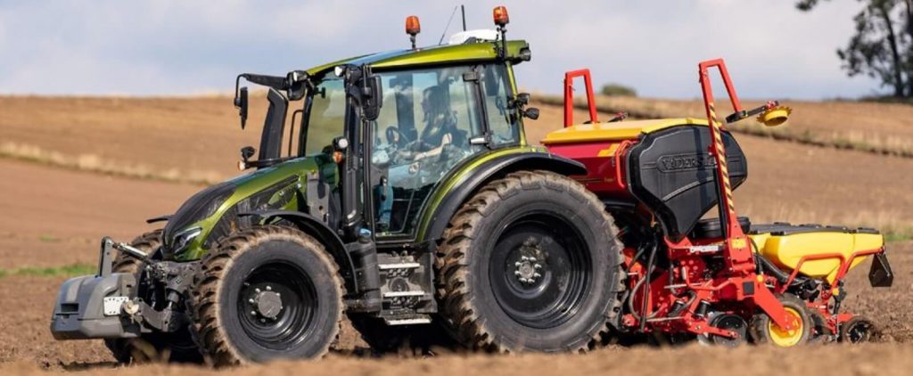 Green Valtra tractor in a farmers field