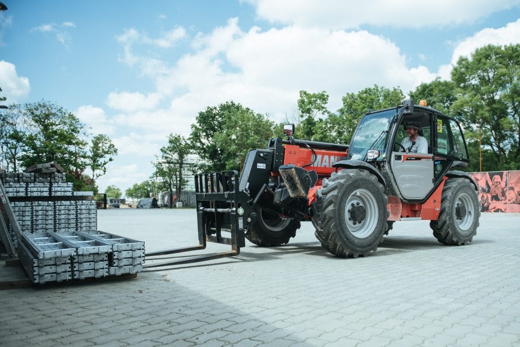 Manitou vehicle picking up some goods