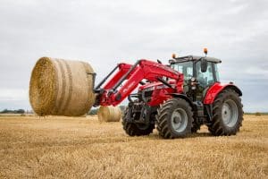 Massey Ferguson loader lifting a bale