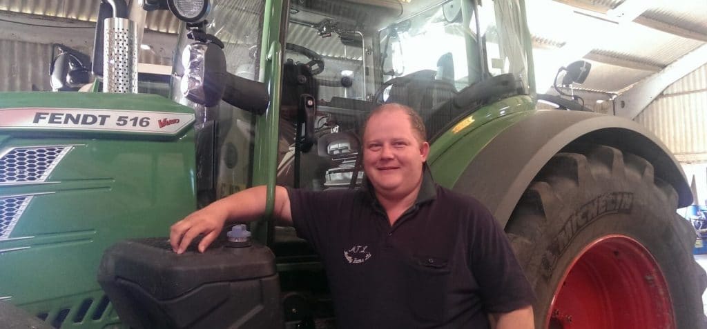 Richard Gay in front of a tractor inside a warehouse