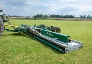 Winged roller mower trailed