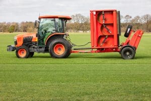 Kubota L2 Series Compact Tractor mowing grass