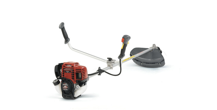 A Honda Brushcutter in red black and grey on a white background.