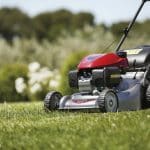 HRG 466 SK petrol lawn mower in action cutting a well maintained green lawn