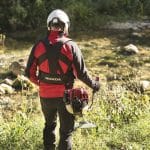 Honda Umk435 Xeet 47Cc Bike Handle Petrol Brushcutter in action with a man in safety gear by a stream