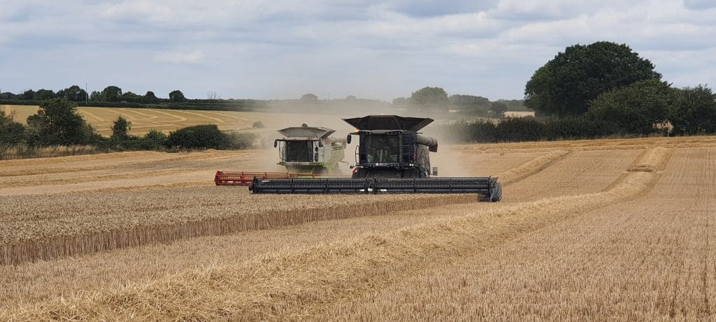 Massy Ferguson and Claas Combine in Field