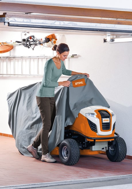 A Stihl Rt 5097 Z Petrol Ride On Lawn Mower stored in a garage