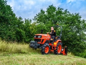 Kubota EK1 compact tractor mowing grass