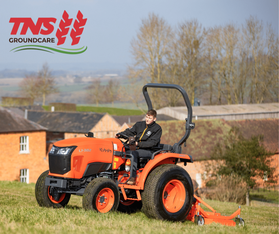 Kubota L1 compact tractor mowing grass