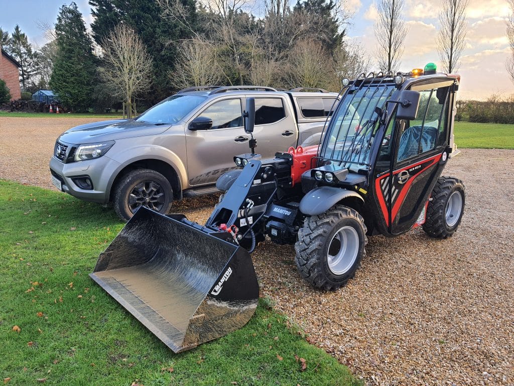 The compact Manitou ULM handler next to a truck