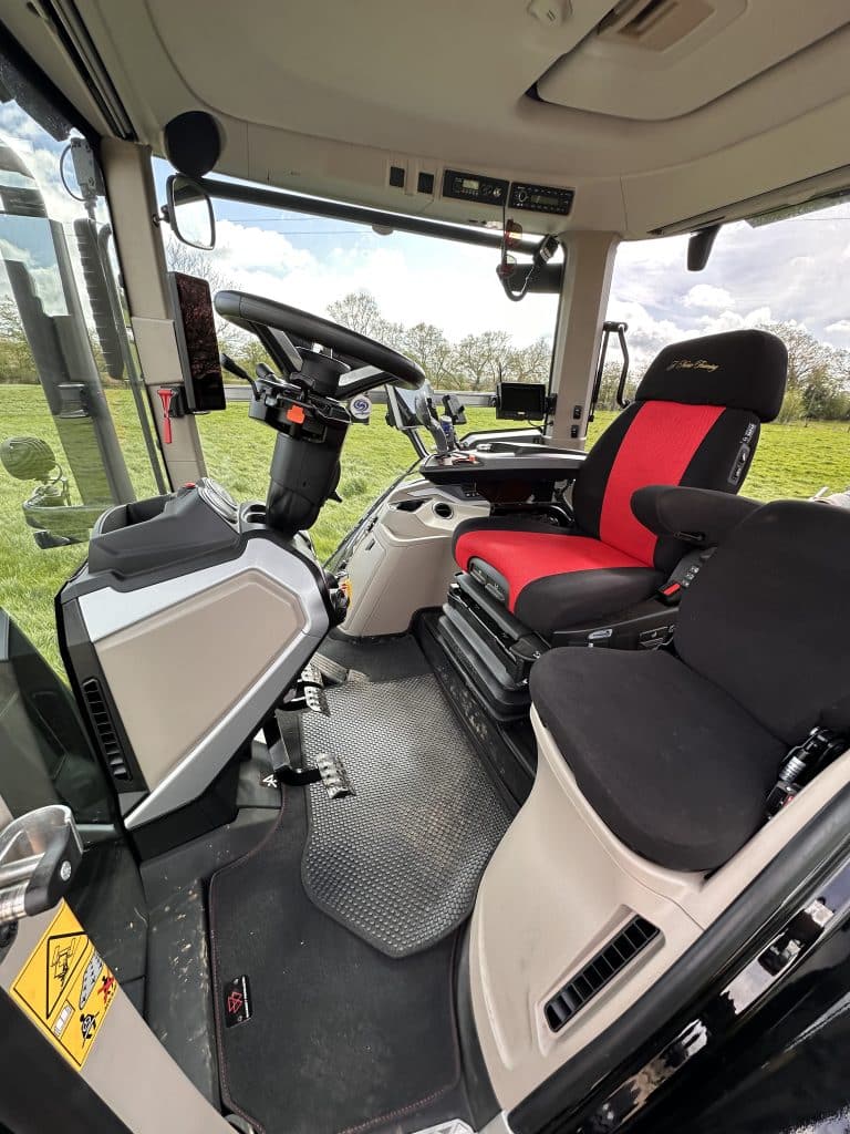 MF 8S cab interior. The seat cover incorporates the John Nurse Farming logo in gold lettering.