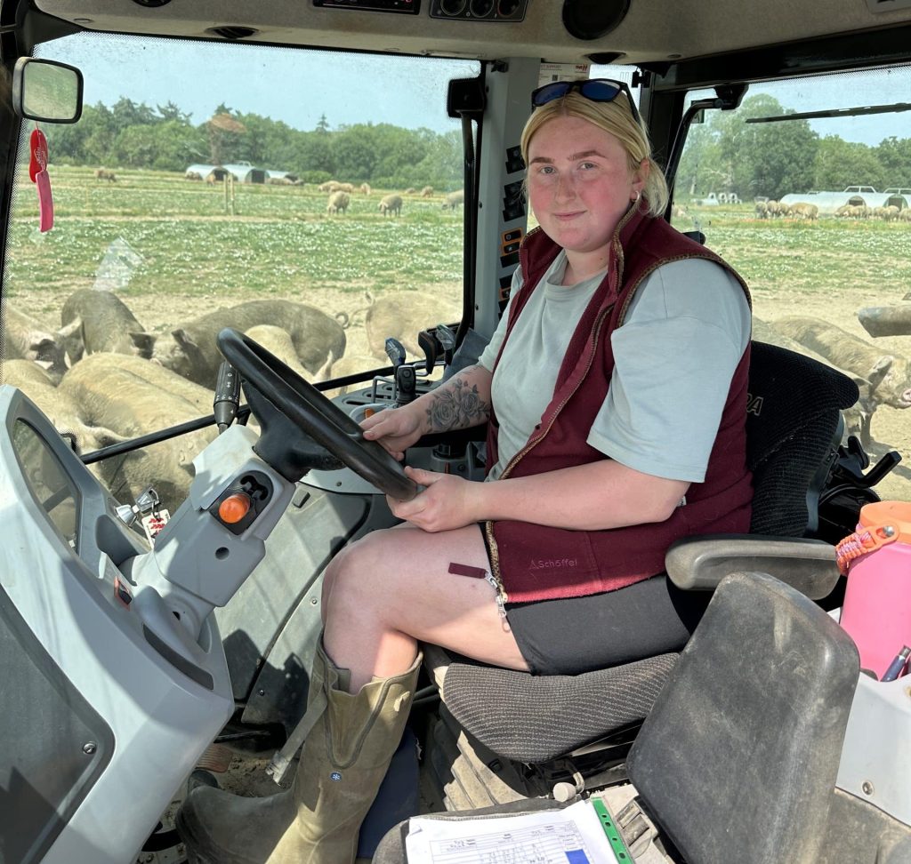 Dry Sow Unit Manager, Charlotte Hurst, in a Valtra tractor