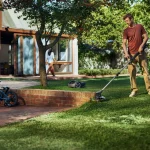 Husqvarna Aspire™ T28-P4A Cordless Grass Trimmer In Use